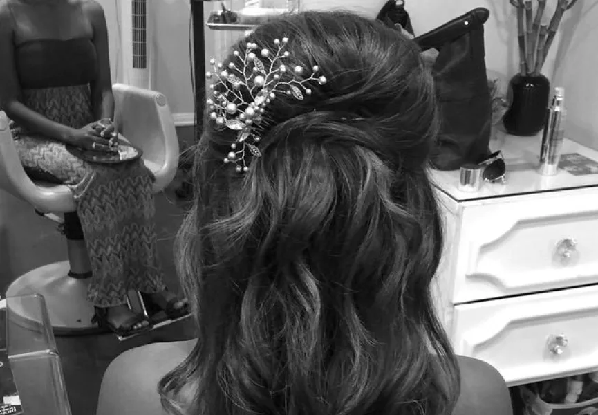 Bridal updo with a hair accessory in black and white
